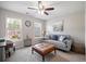 Cozy living room features a leather ottoman, sofa and natural light at 5296 Camden Lake Nw Pkwy, Acworth, GA 30101