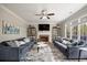 A cozy living room with comfortable sofas, a fireplace with decorative shelving and plenty of natural light at 5296 Camden Lake Nw Pkwy, Acworth, GA 30101