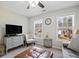 Comfortable sitting room features a television, sofa, and ottoman at 5296 Camden Lake Nw Pkwy, Acworth, GA 30101