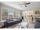 A cozy living room with large windows and a casual dining area and kitchen in the background at 5296 Camden Lake Nw Pkwy, Acworth, GA 30101