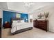 Comfortable main bedroom with a blue accent wall and furnishings at 5296 Camden Lake Nw Pkwy, Acworth, GA 30101