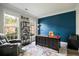 A dedicated home office space with large windows, a comfortable chair, and a stylish modern desk at 5296 Camden Lake Nw Pkwy, Acworth, GA 30101
