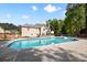 Inviting backyard pool featuring a basketball hoop, patio area, and lush landscaping, perfect for relaxation and entertaining at 5296 Camden Lake Nw Pkwy, Acworth, GA 30101