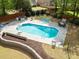 Backyard pool area with lounge chairs, dining area, and landscaping, offering a serene outdoor living experience at 5296 Camden Lake Nw Pkwy, Acworth, GA 30101