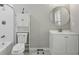 Cozy bathroom featuring white fixtures, subway tile, and a round mirror at 828 Canterbury Overlook Ne, Atlanta, GA 30324