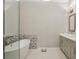 Bright bathroom featuring soaking tub with tile accent wall and a sleek vanity with vessel sink at 828 Canterbury Overlook Ne, Atlanta, GA 30324