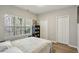 Well-lit bedroom boasts hardwood floors, a large window, and spacious closets at 828 Canterbury Overlook Ne, Atlanta, GA 30324