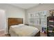 Comfortable bedroom with a warm wood bed frame and natural light from a large window at 828 Canterbury Overlook Ne, Atlanta, GA 30324