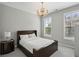 Bright bedroom featuring a striped wood bed frame, plush carpet, and elegant chandelier at 828 Canterbury Overlook Ne, Atlanta, GA 30324