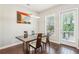 Elegant dining room featuring hardwood floors, a stylish light fixture, and a door to the patio at 828 Canterbury Overlook Ne, Atlanta, GA 30324