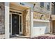 Inviting front entrance with a dark front door, brick and stone facade, and attached garage at 828 Canterbury Overlook Ne, Atlanta, GA 30324