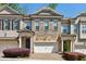 Charming brick townhouse with stone accents, covered porch, and attached two-car garage at 828 Canterbury Overlook Ne, Atlanta, GA 30324