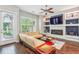 Cozy living room featuring hardwood floors, a ceiling fan, and a modern fireplace at 828 Canterbury Overlook Ne, Atlanta, GA 30324