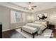 Cozy bedroom with wood floors, ceiling fan, bench, and large window at 828 Canterbury Overlook Ne, Atlanta, GA 30324