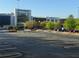 Entrance to Lenox Square mall with a modern glass facade, surrounded by trees and parking spaces at 828 Canterbury Overlook Ne, Atlanta, GA 30324