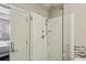 Modern glass-enclosed shower with marble wall tile and mosaic accents at 828 Canterbury Overlook Ne, Atlanta, GA 30324