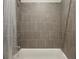 Tiled shower and tub combo with chrome fixtures and shower curtain at 828 Canterbury Overlook Ne, Atlanta, GA 30324