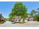 Charming townhomes with attached garages, well-manicured landscaping and mature trees under a bright blue sky at 828 Canterbury Overlook Ne, Atlanta, GA 30324