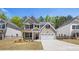 New construction home showcasing its manicured front yard, two-car garage, and brick accents at 13918 Homer Ln, Covington, GA 30014
