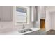 Close up of kitchen with gray cabinets, white countertops, and stainless steel appliances at 13918 Homer Ln, Covington, GA 30014