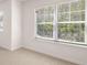 Brightly lit carpeted room with large windows featuring natural light and outdoor scenery at 13918 Homer Ln, Covington, GA 30014
