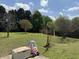 Large grassy backyard with a swing set and baseball net at 140 Grayview Ct, Grayson, GA 30017