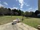 Large grassy backyard with a swing set and baseball net for outdoor sports at 140 Grayview Ct, Grayson, GA 30017