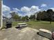 Backyard patio with barbecue grill and picnic table adjacent to a spacious lawn and playground set at 140 Grayview Ct, Grayson, GA 30017