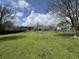 Large backyard with green grass, surrounded by a wooden fence, with a play structure and plenty of room to play at 140 Grayview Ct, Grayson, GA 30017