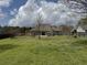 Lush, green backyard with a well-maintained lawn and a play set, providing a great space for to play at 140 Grayview Ct, Grayson, GA 30017