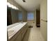 Bathroom with a double sink vanity, large window, soaking tub, and walk-in shower at 140 Grayview Ct, Grayson, GA 30017