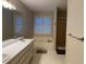 Well-lit bathroom features a large soaking tub, window, and double sink vanity at 140 Grayview Ct, Grayson, GA 30017
