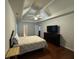 Spacious bedroom with tray ceilings, ceiling fan, and a dark dresser with television at 140 Grayview Ct, Grayson, GA 30017