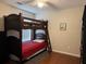 Bedroom featuring a bunk bed, window with blinds, neutral walls, and hardwood floors for a comfortable space at 140 Grayview Ct, Grayson, GA 30017