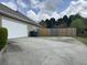 Wide driveway provides ample parking, complemented by a fenced yard and well-maintained surroundings at 140 Grayview Ct, Grayson, GA 30017