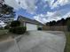Spacious driveway leading to a two-car garage surrounded by landscaping, offering ample parking space at 140 Grayview Ct, Grayson, GA 30017