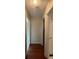 Hallway with hardwood floors, neutral paint, and doors leading to various rooms offers easy navigation at 140 Grayview Ct, Grayson, GA 30017
