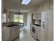 Well-lit kitchen with white cabinets and appliances, providing a clean and functional space for cooking and meal prep at 140 Grayview Ct, Grayson, GA 30017