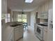 Clean kitchen with white cabinets and appliances, offering a practical and efficient space for cooking and everyday living at 140 Grayview Ct, Grayson, GA 30017