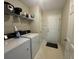 Functional laundry room with washer, dryer, shelving, and a door leading outside at 140 Grayview Ct, Grayson, GA 30017