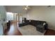 Open living room with vaulted ceilings, wood floors and view to kitchen and dining room at 140 Grayview Ct, Grayson, GA 30017