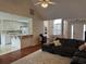 Open living room showing view to kitchen and dining room with vaulted ceilings and wood floors at 140 Grayview Ct, Grayson, GA 30017