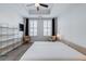 Airy bedroom features large windows with plantation shutters, neutral decor, and a modern ceiling fan for a calm ambiance at 325 E Paces Ferry Ne Rd # 1405, Atlanta, GA 30305