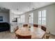 Open-concept dining room with a wooden table, modern lighting, and views of the kitchen and living areas at 325 E Paces Ferry Ne Rd # 1405, Atlanta, GA 30305
