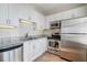 Updated kitchen features white cabinets, stainless steel appliances, and modern lighting for a sleek and stylish look at 325 E Paces Ferry Ne Rd # 1405, Atlanta, GA 30305