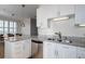 Well-lit kitchen boasts white cabinets, granite countertops, stainless steel appliances, and an island with barstool seating at 325 E Paces Ferry Ne Rd # 1405, Atlanta, GA 30305