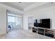 Bright living room with hardwood floors, a sliding door to a balcony, and an entertainment center at 325 E Paces Ferry Ne Rd # 1405, Atlanta, GA 30305