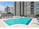 Outdoor community pool with lounge chairs and high-rise building in the background on a sunny day at 325 E Paces Ferry Ne Rd # 1405, Atlanta, GA 30305