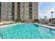 Inviting community pool with comfortable lounge chairs and city backdrop at 325 E Paces Ferry Ne Rd # 1405, Atlanta, GA 30305