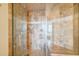 Luxurious walk-in shower features beautiful brown and beige stone tiling, and a glass door at 325 E Paces Ferry Ne Rd # 1405, Atlanta, GA 30305